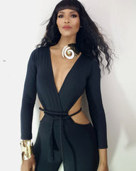 A woman in a black outfit with a Nik Spruill AMENZA gold necklace.