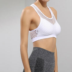 A woman wearing a YABEI X Nik Spruill You Are The One Crop White sports bra and grey leggings.