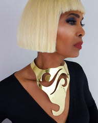 A woman with blonde hair wearing a Nik Spruill NAWI gold collar.