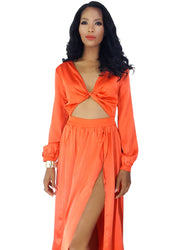 A woman wearing a Nik Spruill Effortless Double Slit Maxi Dress - Orange.