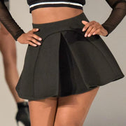 A woman in a Nik Spruill Spectator Skirt and a black and white top.