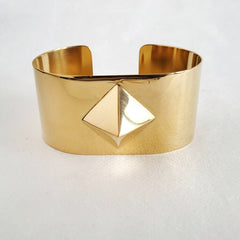 A Nik Spruill ISIS cuff with a triangle on it.