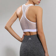 The back view of a woman wearing a YABEI X Nik Spruill YOU ARE THE ONE CROP WHITE sports bra.
