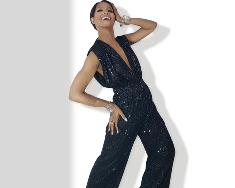 A woman in a Nik Spruill Glitz Sequined Jumpsuit - Black posing for a picture.