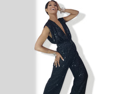 A woman in a Nik Spruill Glitz Sequined Jumpsuit - Black posing for a picture.