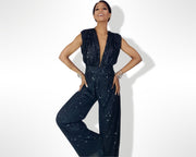 A woman in a Nik Spruill Glitz Sequined Jumpsuit - Black posing for a picture.