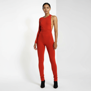 Woman wearing a red jumpsuit on a white background