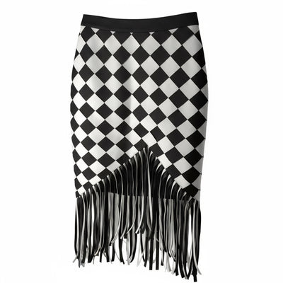 Discover the Nik Spruill Checkmate Crochet Fringe Skirt—a stylish black and white checkered piece with a fringed hem. Crafted with a crochet interlock technique and color block design, it's elegantly showcased on a hanger.
