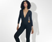 Model wearing a black jumpsuit unitard with cut out panels by Nik spruill