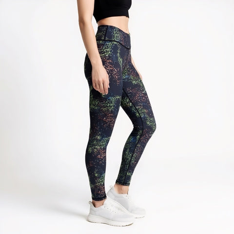 Multicolored patterned leggings worn by a person on a white background
