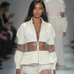 Model confidently walks the runway wearing a Nik Spruill OCEAN 7 JACKET, crafted from semi-transparent, three-dimensional spacer fabric, paired with a fringe skirt.