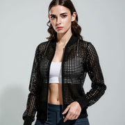 Woman wearing a black studded jacket on a gray background