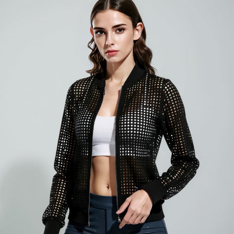 Woman wearing a black studded jacket on a gray background