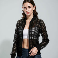 Woman wearing a black studded jacket on a gray background