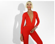 A woman is posing in a Nik Spruill Jade cutout backless jumpsuit - red.