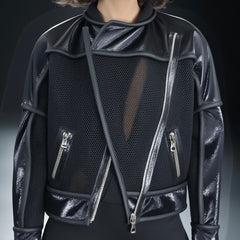 A person models the Nik Spruill FREEDOM JACKET against a plain background, showcasing its sleek design crafted from exotic leather with multiple metal zippers for an edgy flair.