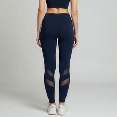 Navy blue leggings with mesh panels worn by a person on a light gray background