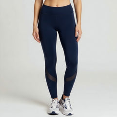 Navy blue leggings with mesh panels worn by a person on a white background