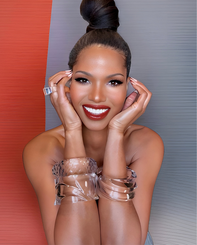 A person with a styled updo and bright smile poses against a divided red and gray background, wearing a Luminous Lucite Cuff Bangle Bracelet by Nik Spruill.