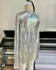 A mannequin showcases the Nik Spruill SIVA Steel Sequin Fringe Jacket featuring fringe details, elegantly posed from the back in front of a large printer.