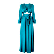 Teal dress with long sleeves and a tied waist on a white background