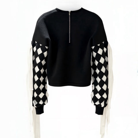Black sweater with checkered sleeves on a white background