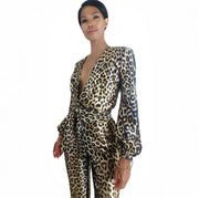 Woman wearing a leopard print jumpsuit on a white background
