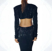 Black sequin outfit worn by a person on a white background back view