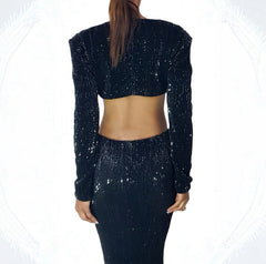 Black sequin outfit worn by a person on a white background back view