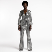 Person wearing a silver metallic jumpsuit on a white background