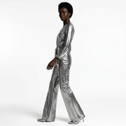 Person wearing a silver metallic jumpsuit on a white background