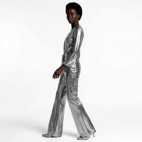 Person wearing a silver metallic jumpsuit on a white background