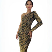 Model with a one shoulder crystal zebra dress with high side slit