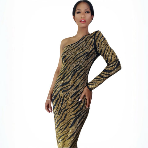 Model with a one shoulder crystal zebra dress with high side slit