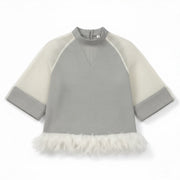 A gray dress with netted sleeves and a detachable feather bottom, accented by white feathers on the hem. 