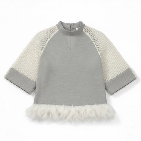 A gray dress with netted sleeves and a detachable feather bottom, accented by white feathers on the hem. 