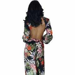 Woman wearing a floral dress with a backless design on a white background