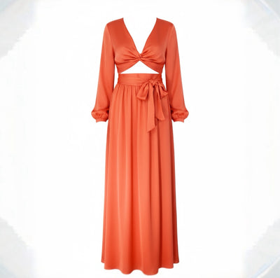 Orange two-piece dress with long sleeves and a tied waist on a white background