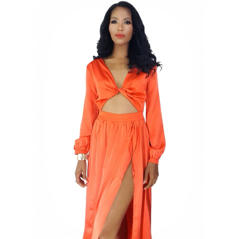 Woman wearing an orange dress with a cutout design on a white background