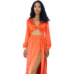 Woman wearing an orange dress with a cutout design on a white background