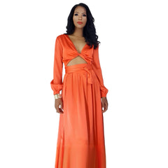 Woman wearing an orange evening gown in a modern interior setting