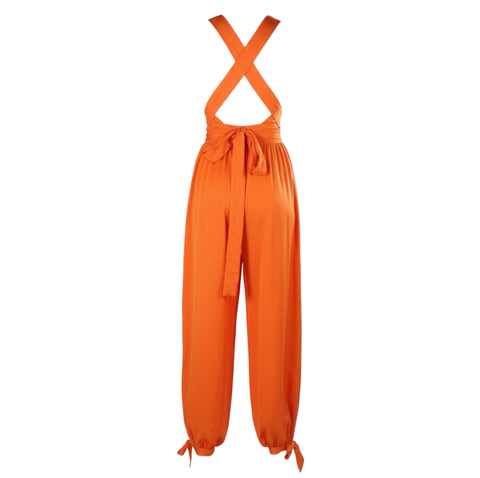 Orange jumpsuit with criss-cross straps on a white background