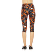 Capri leggings with black floral pattern on orange background