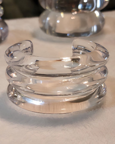 Close-up of the Nik Spruill ARCTIC Lucite Cuff Bracelet with a smooth, curved design, hand-polished and placed on a white surface.