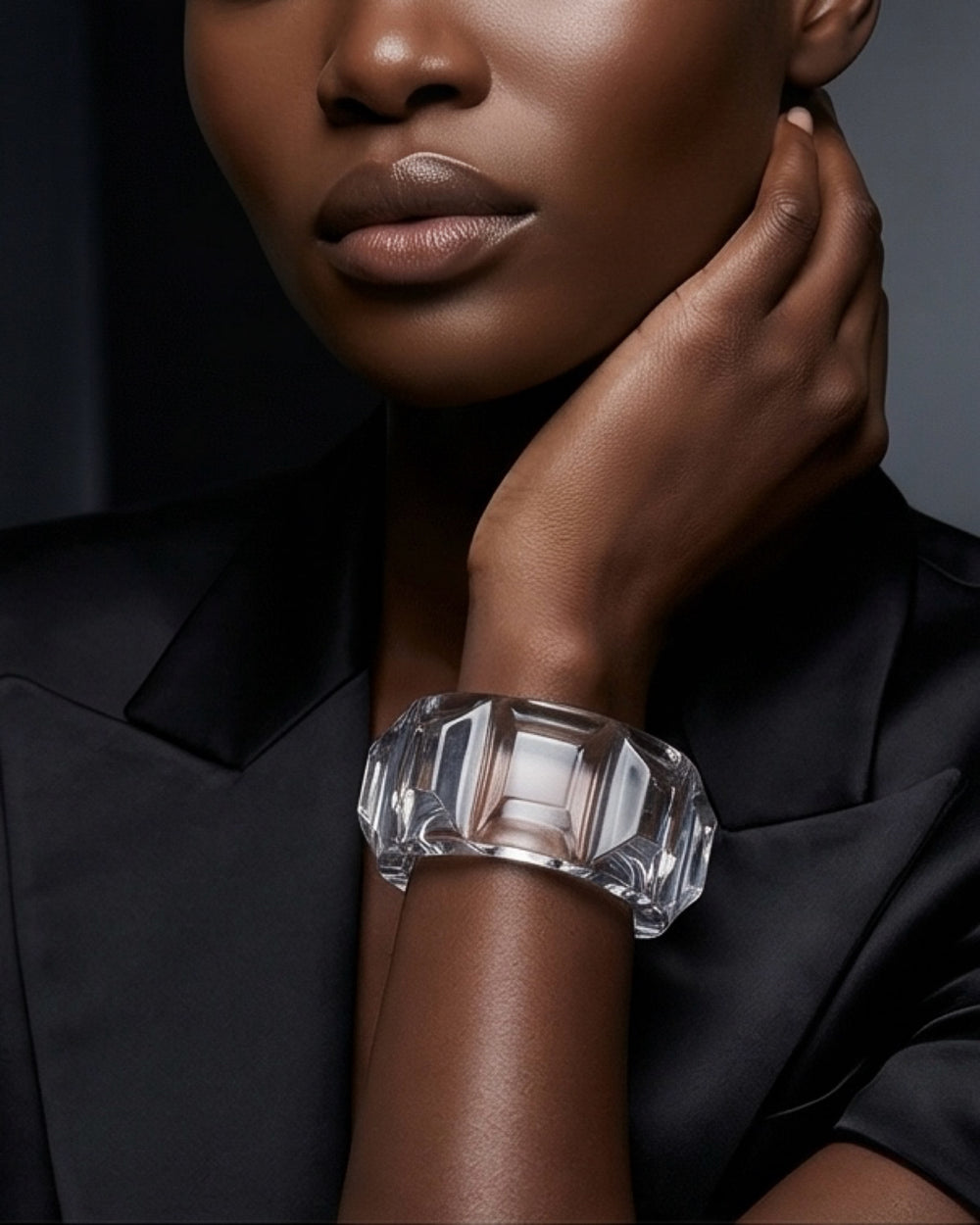 Model wearing clear lucite cuff bracelet, sculptural transparent statement jewelry on wrist