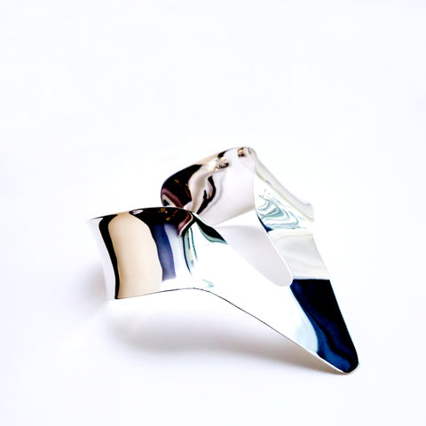 A close up of a Nanisca - Silver tie on a white surface by Nik Spruill.