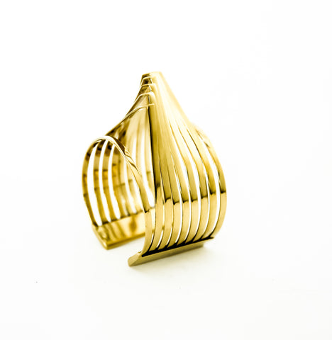 A HERU gold ring on a white background by Nik Spruill.