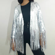 A woman wearing a Nik Spruill SIVA STEEL SEQUIN FRINGE JACKET and black pants.