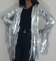 A woman wearing a Nik Spruill SIVA STEEL SEQUIN FRINGE JACKET and black pants.