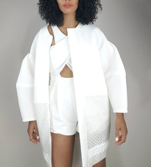 model in a white neoprene net and clear white bell sleeve coat by Nik Spruill